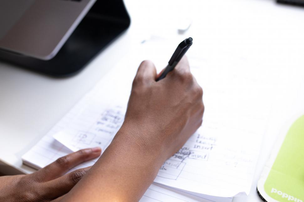 Free Image of Hand of Businesswoman with pen and paper 