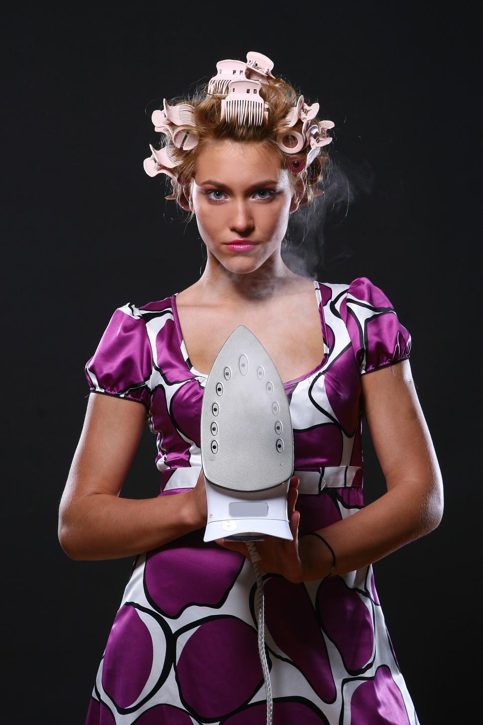Free Image of woman with hair curlers and iron 