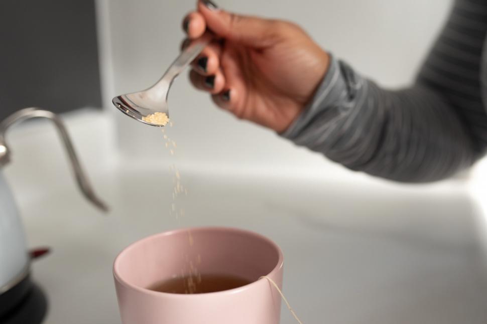 Free Image of Adding sugar into tea cup 