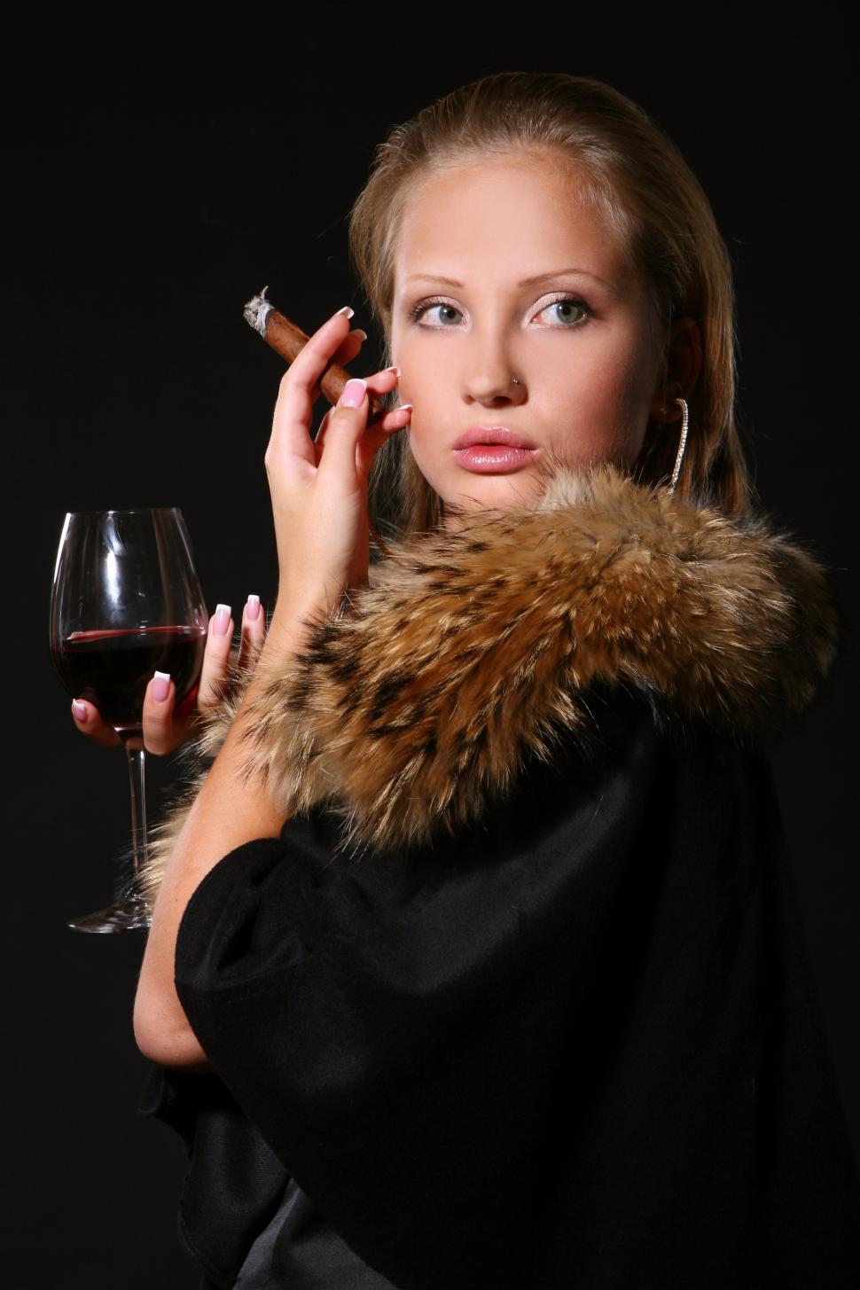 Free Image of elegant woman with wine and cigar 