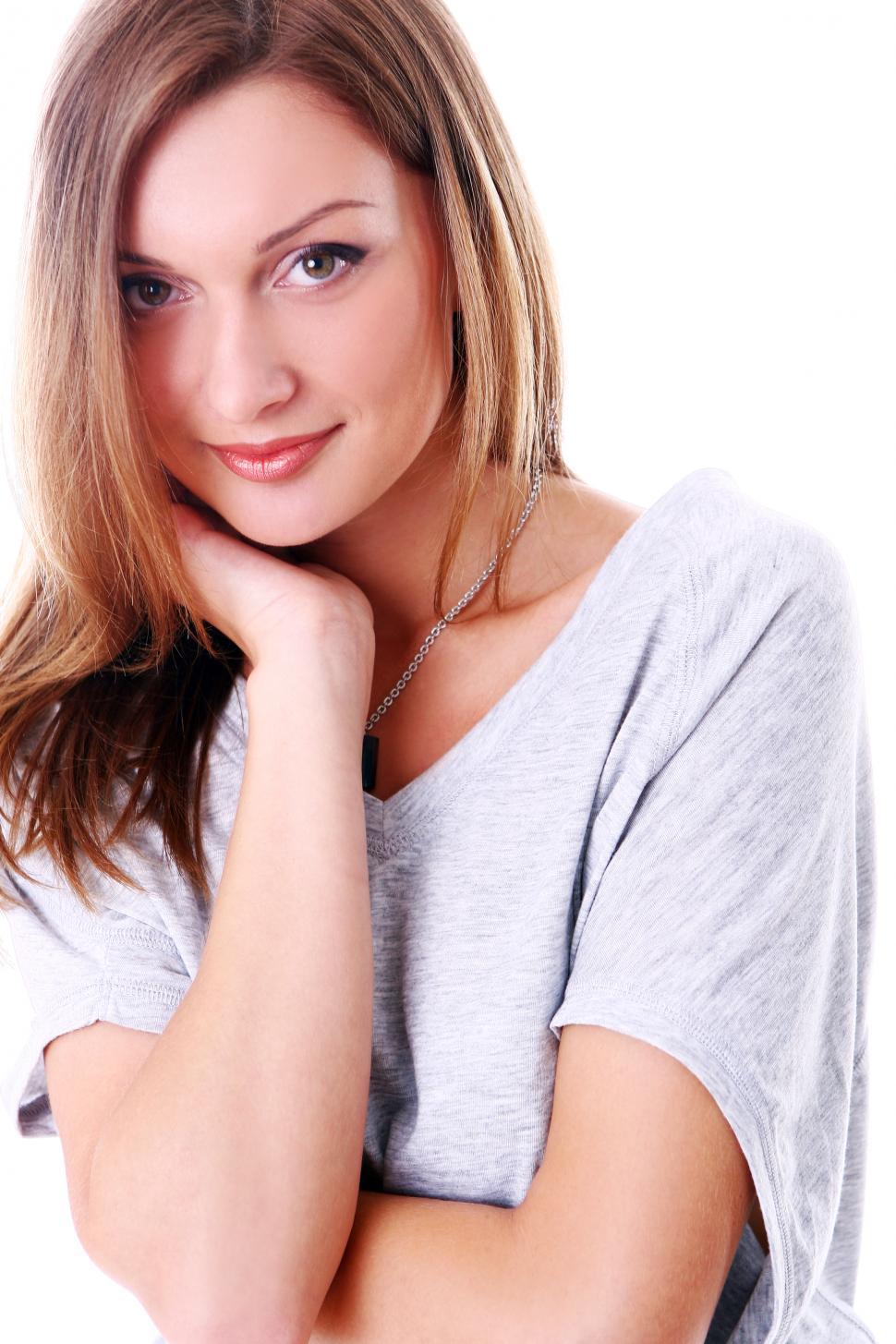 Free Image of Portrait of cute young woman looking at camera, smiling against white backgr 