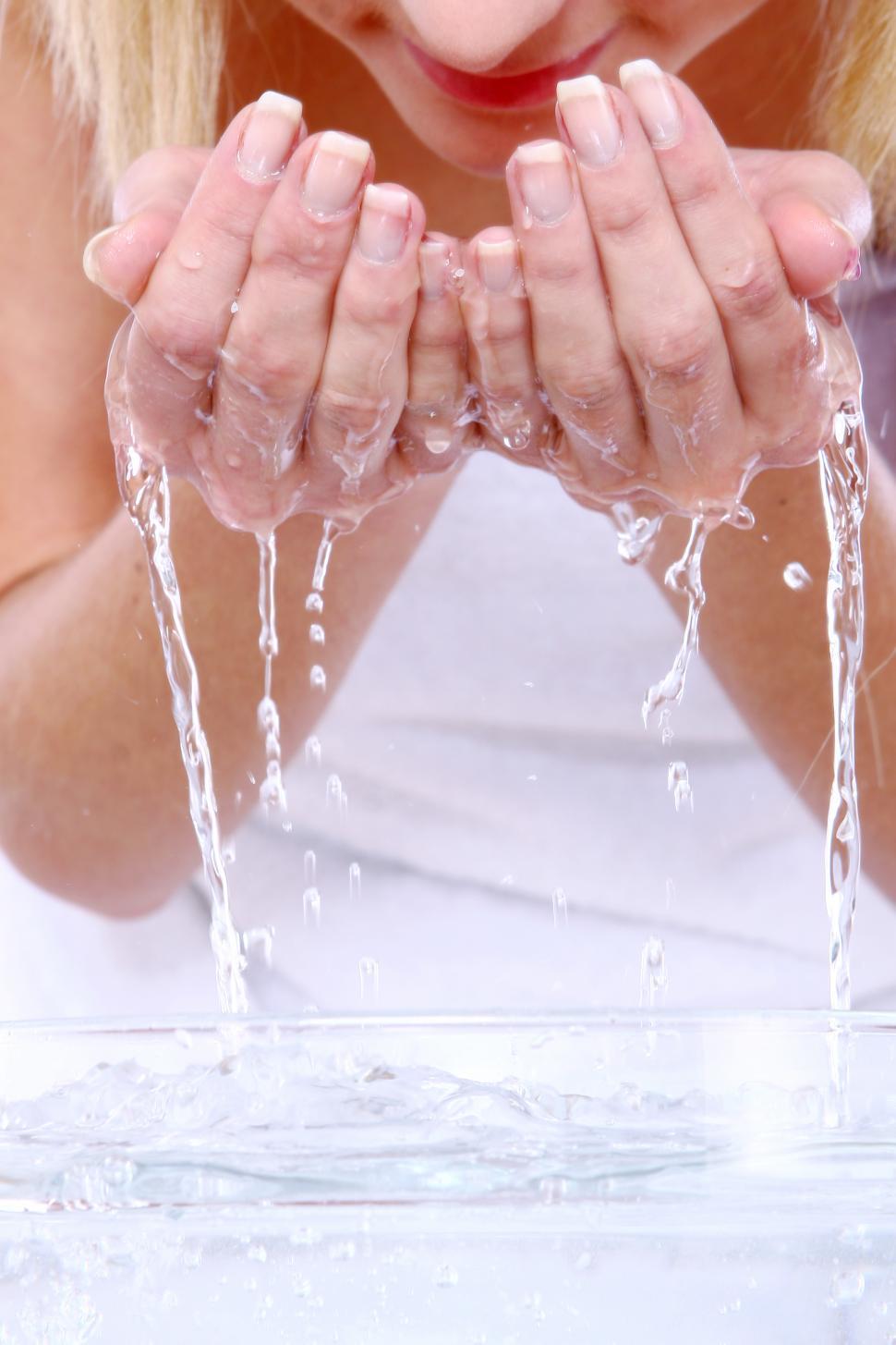 Free Image of Washing face with water in hands 