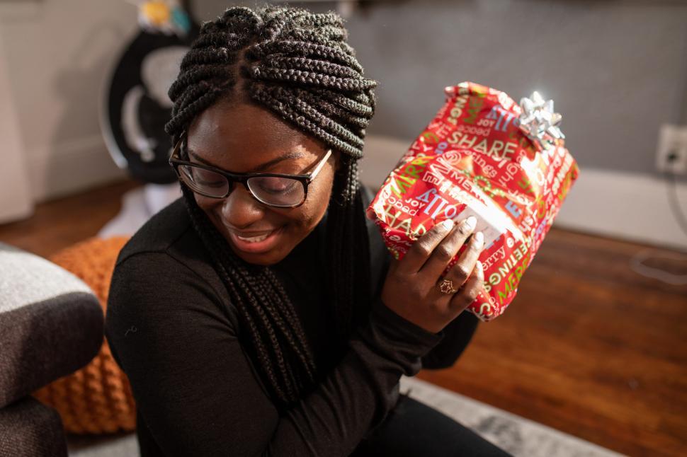Free Image of Young Smiling Woman With Xmas Gift 