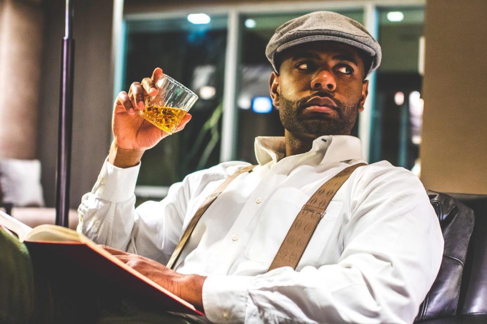 Free Image of Young Man in suspenders with Whiskey Glass - looking away 