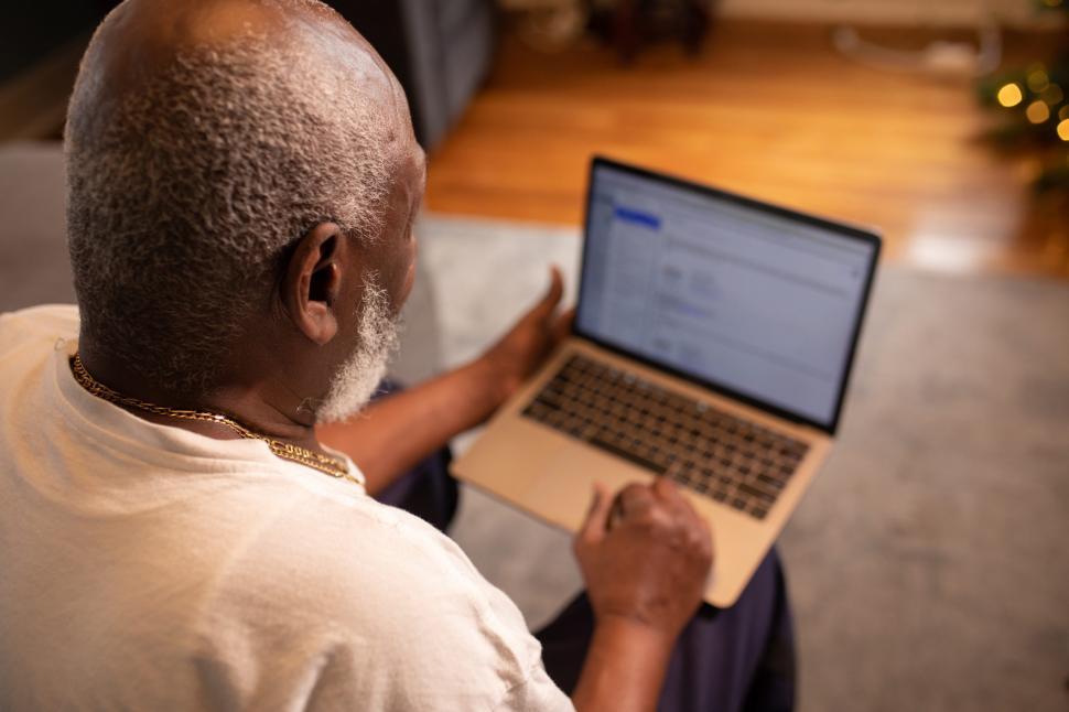 Free Image of Older Man using laptop at home 