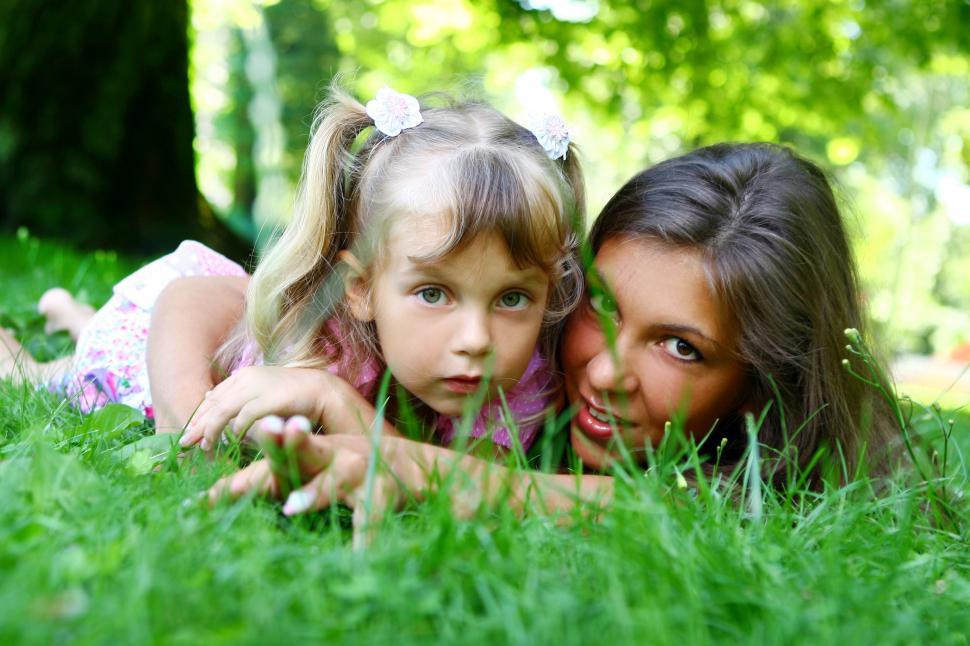 Free Image of sweet girl with mom, laying down, looking at camera 