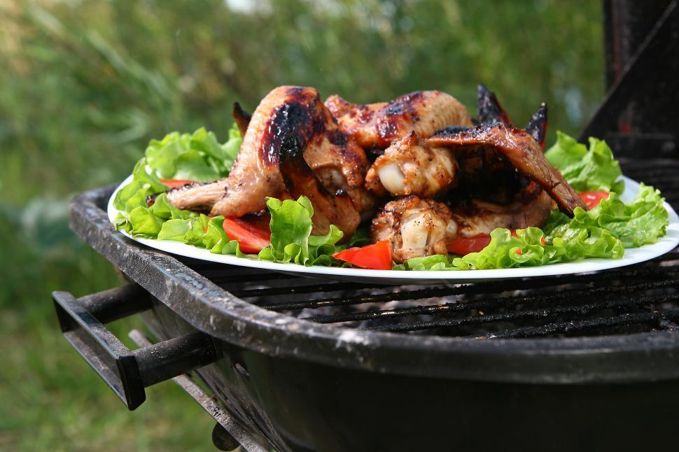 Free Image of chicken legs on the grill with vegetables 