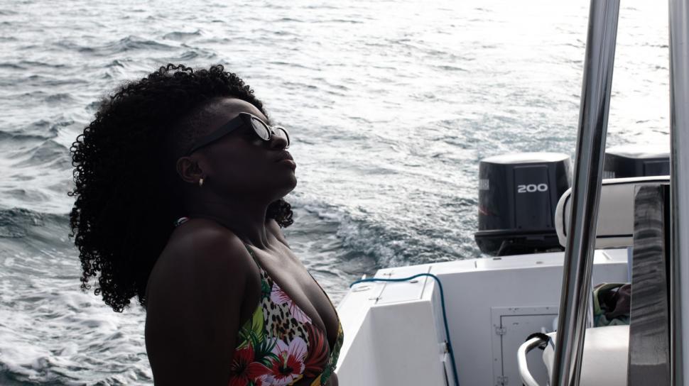 Free Image of Young Woman in Sunglasses with Curly Hair on boat 