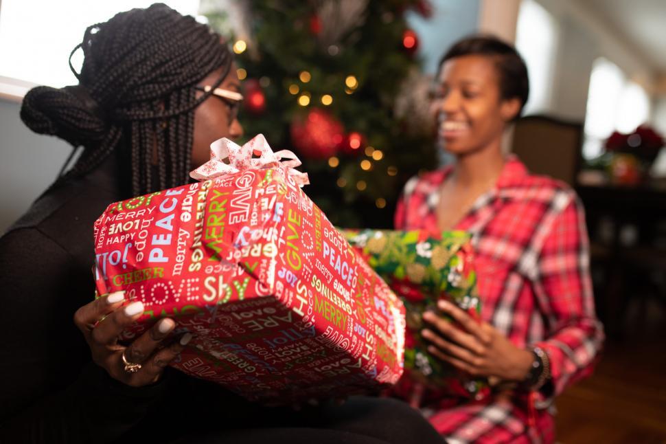 Free Image of Two Women With Christmas Presents 