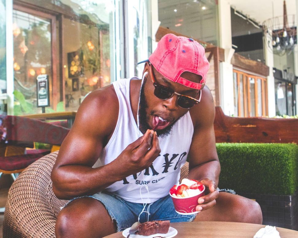 Free Image of Young Man in Pink Cap with ice cream cup 