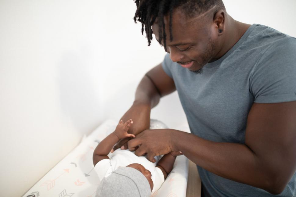 Free Image of Young Father Playing With Newborn Baby 