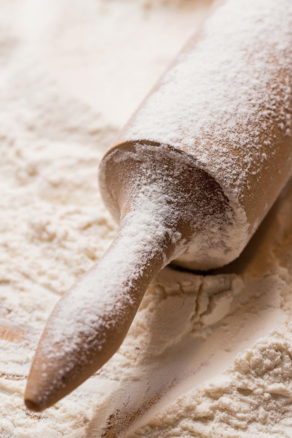 Free Image of Cooking, close-up. Wooden rolling pin in the flour 