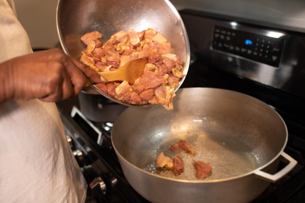 Free Image of Meat pieces frying in cooking pot 