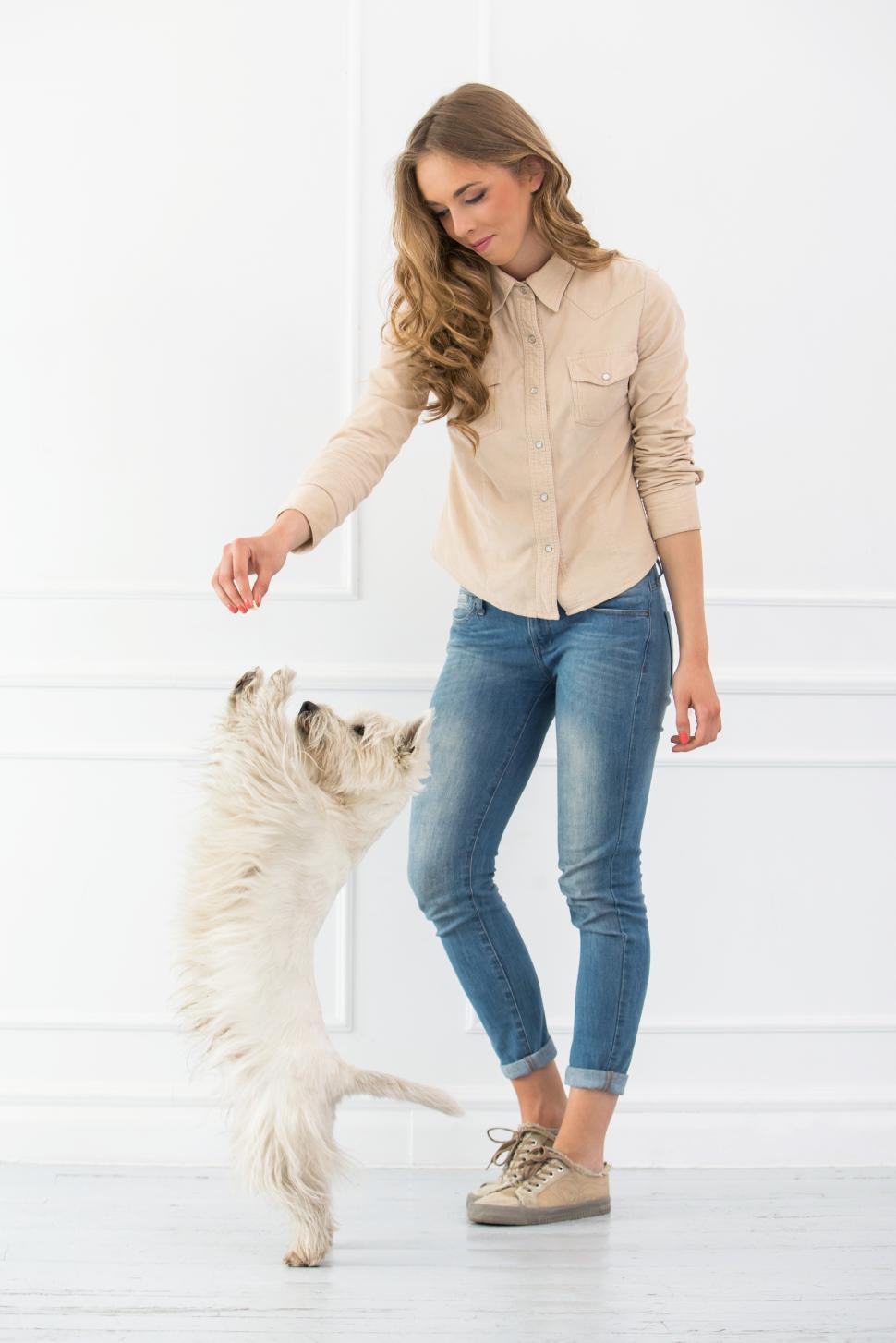 Free Image of Beautiful girl standing with dog 