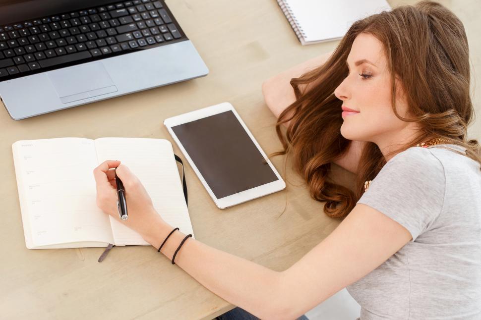 Free Image of Student. Attractive girl writing in journal 