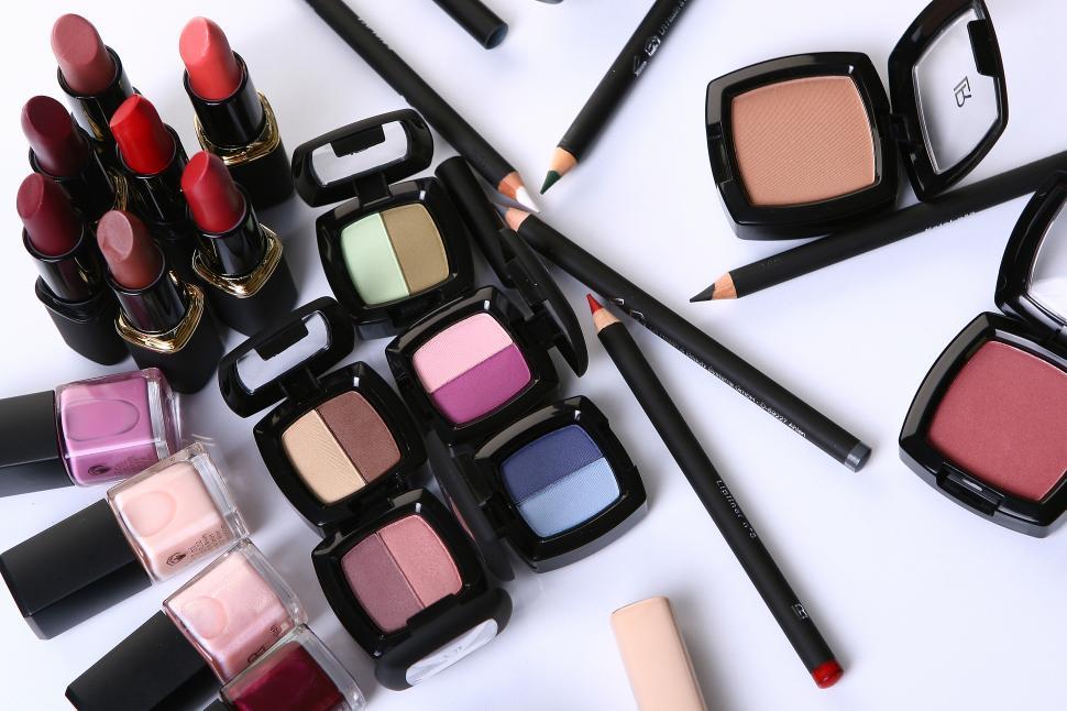 Free Image of Many cosmetics scattered on a table 