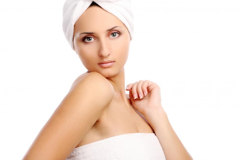 Free Image of Young woman wearing a towel looking over shoulder 