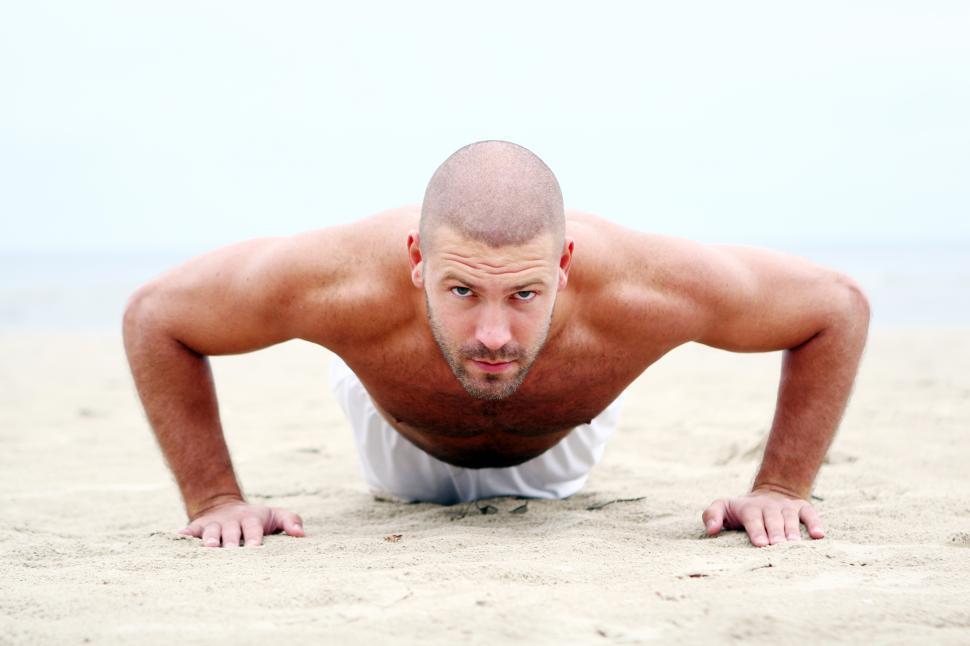 Free Image of Doing pushups on the sandy beach 