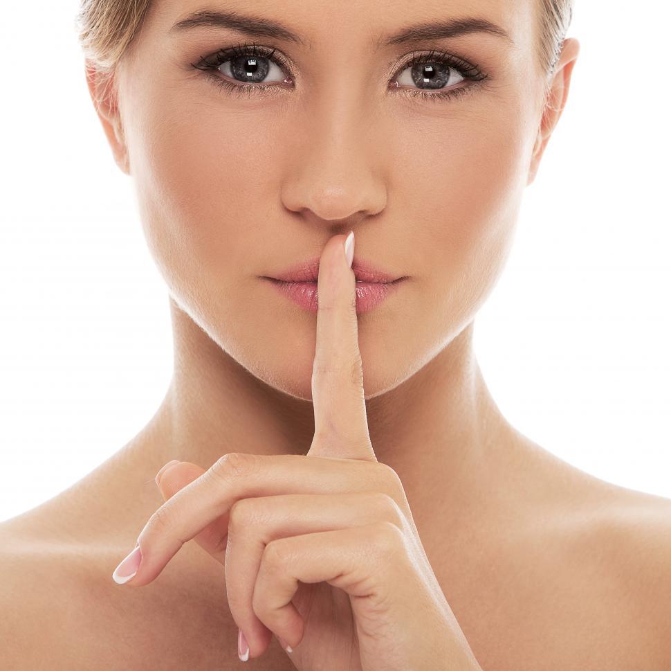 Download Free Stock Photo of Woman shushing with finger to lips 