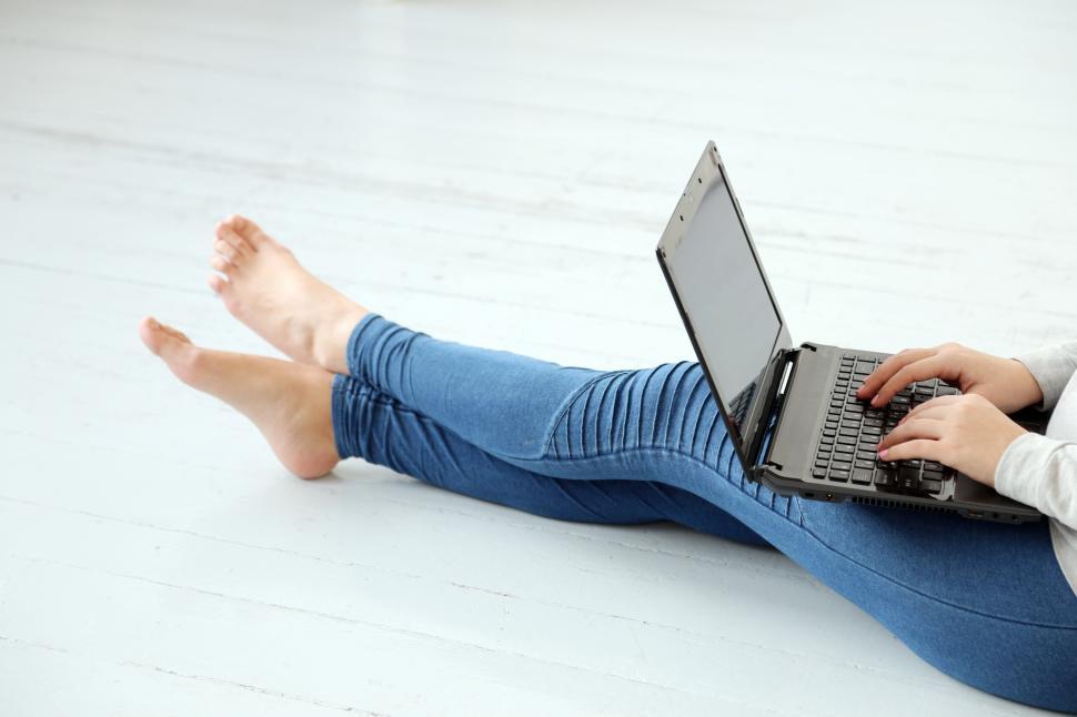 Download Free Stock Photo of Girl on the ground with a laptop, typing away 