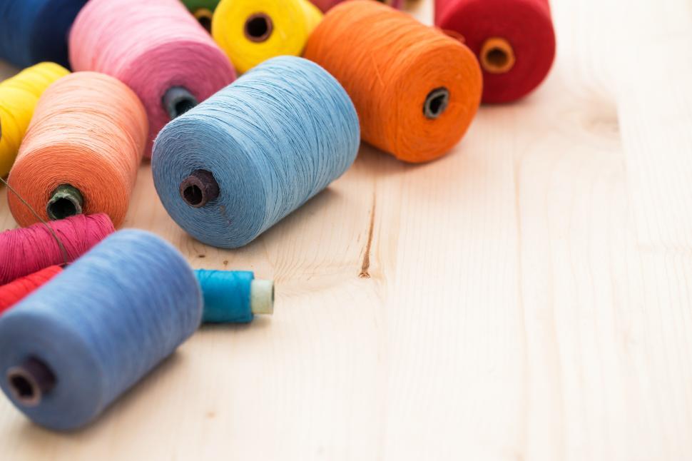 Download Free Stock Photo of Colorful threads on the table with copyspace 