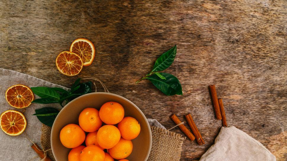 Free Image of Fresh and Dried Mandarins on the table with cinnamon 