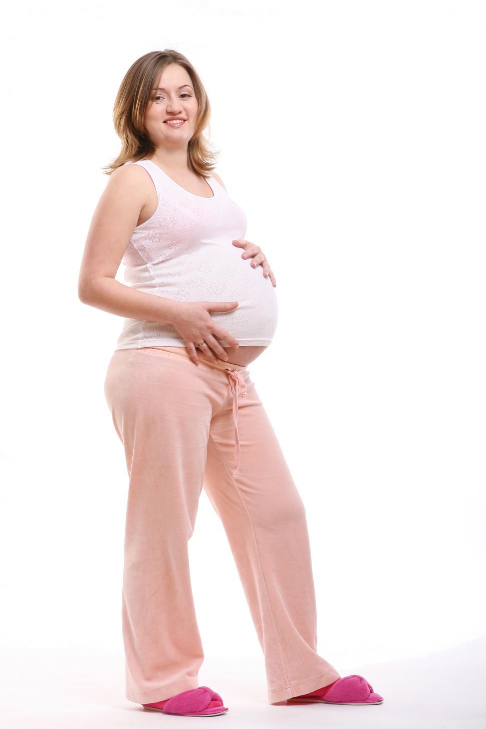 Free Image of happy pregnant young woman with hands on her belly 