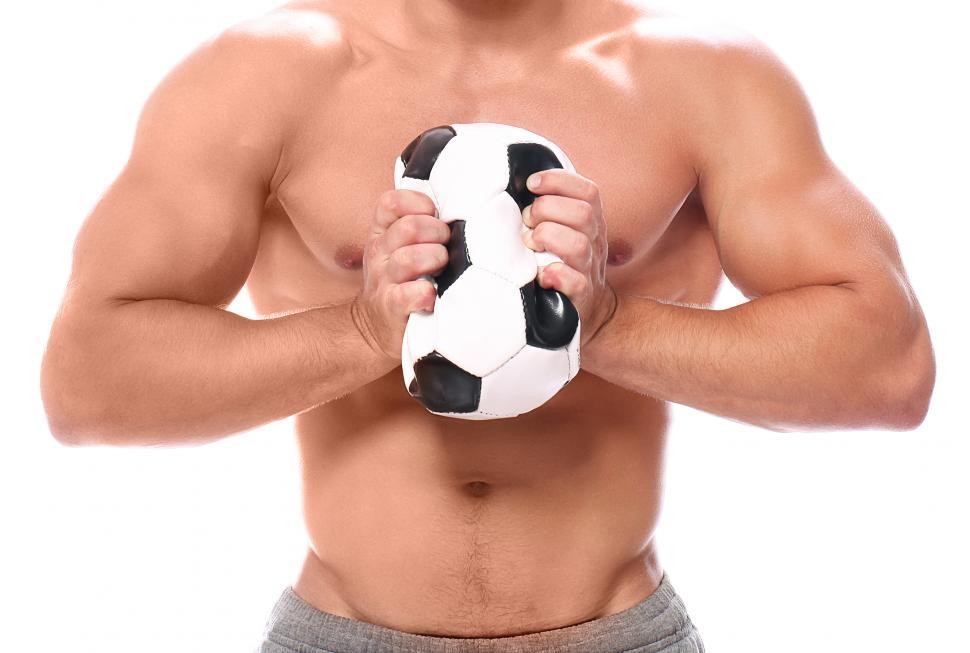 Free Image of Strong man squeezing soccer ball 