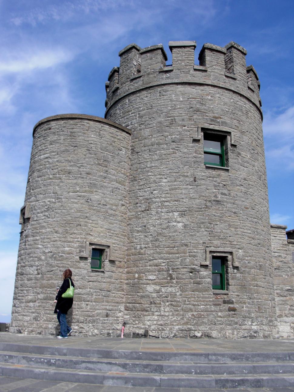 Free Image of Person Standing in Front of a Stone Castle 