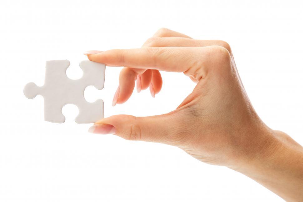 Free Image of One hand holding one white puzzle piece 