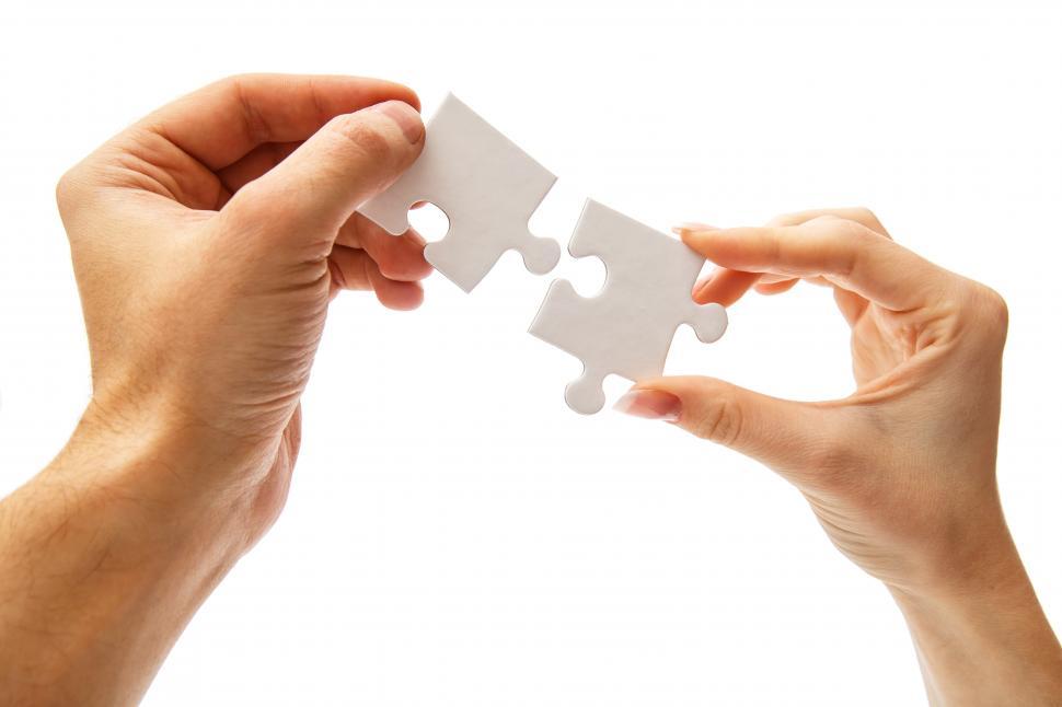 Free Image of Two white puzzle pieces fitting together 