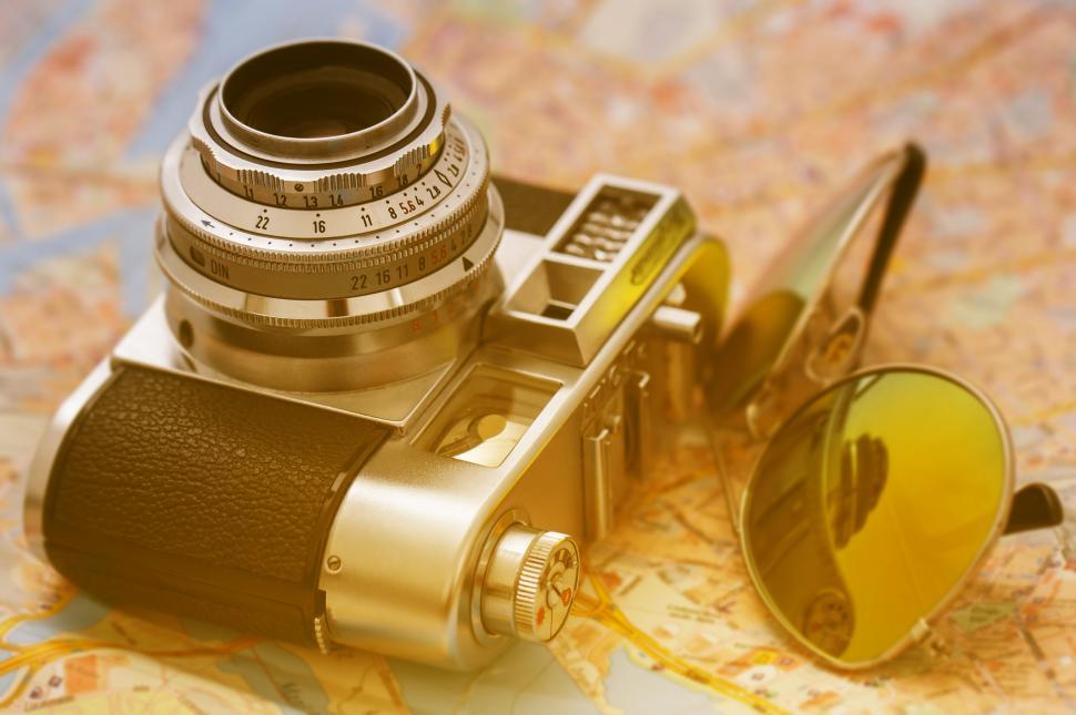 Free Image of Retro camera and glasses on a map 