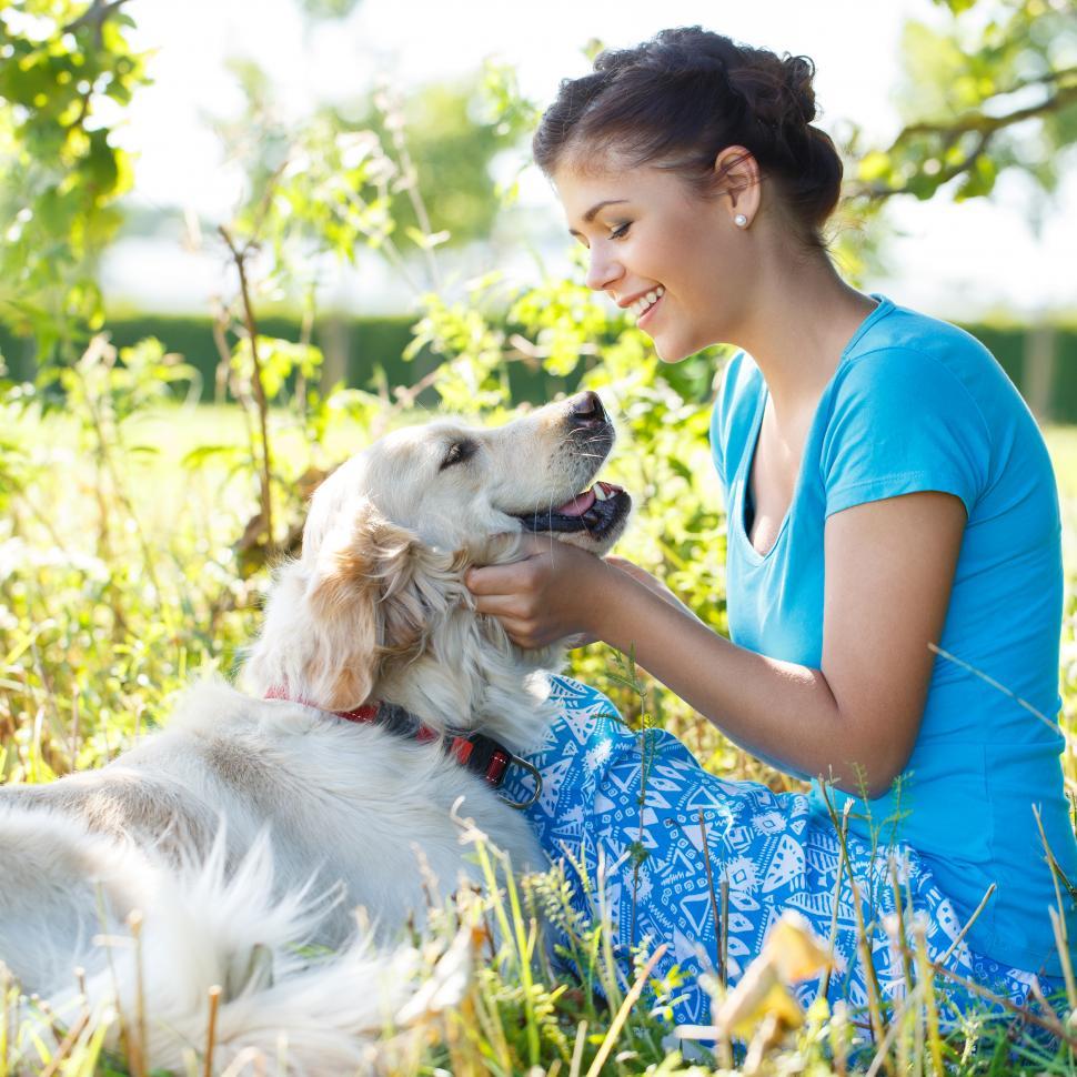 Free Image of Woman outdoors enjoying time with dog 
