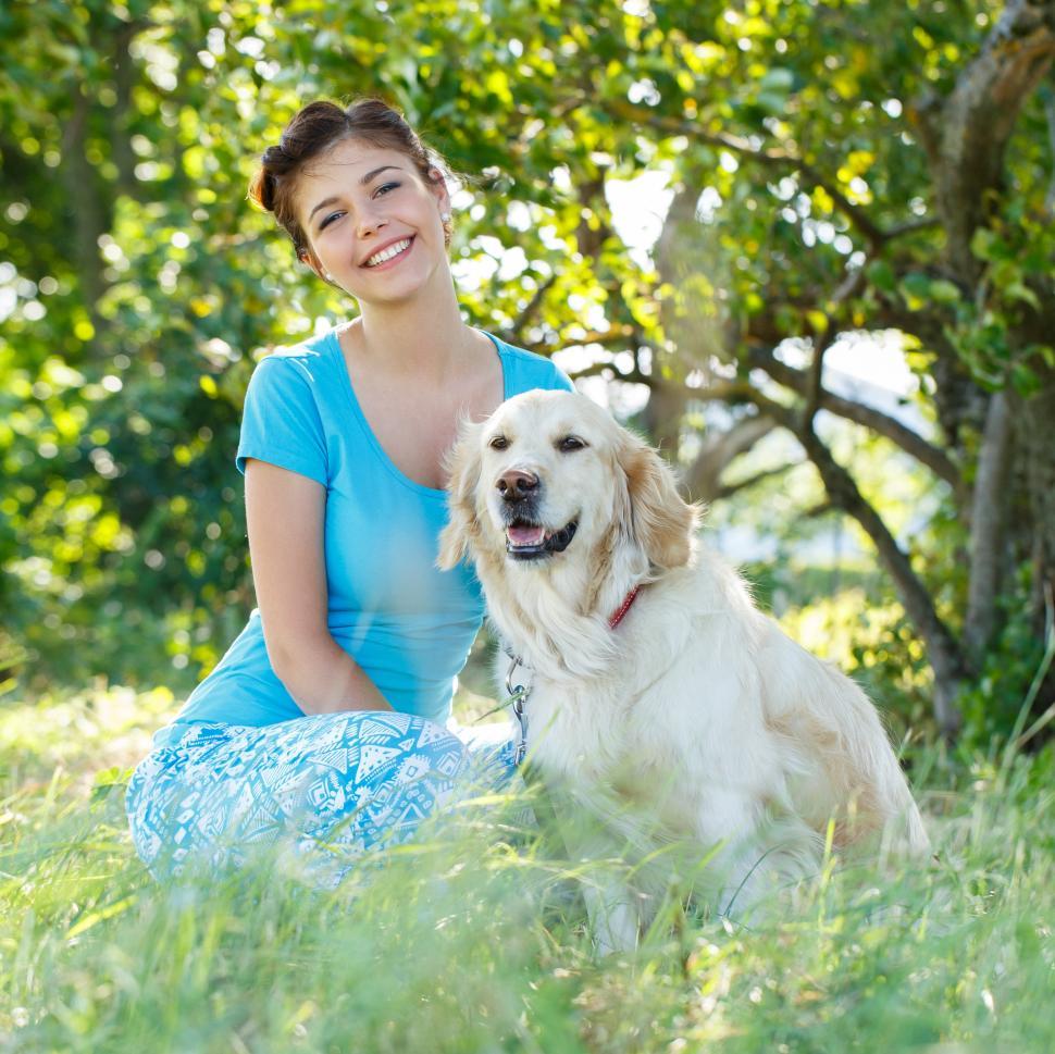 Free Image of Woman and her dog in a field in the spring 