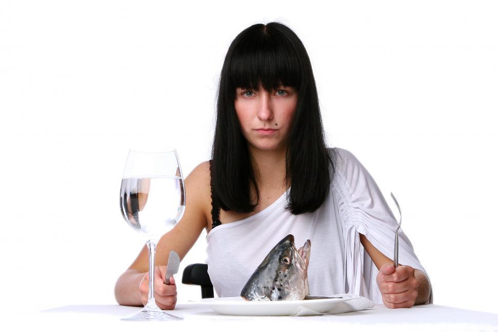 Free Image of Woman ready to dig in to a fresh fish head 