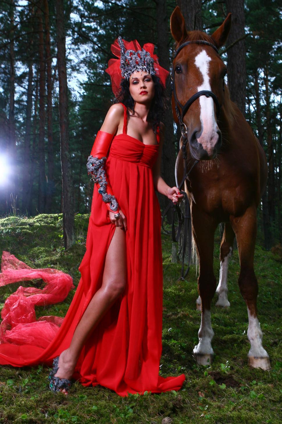 Free Image of Woman in red dress with a horse 