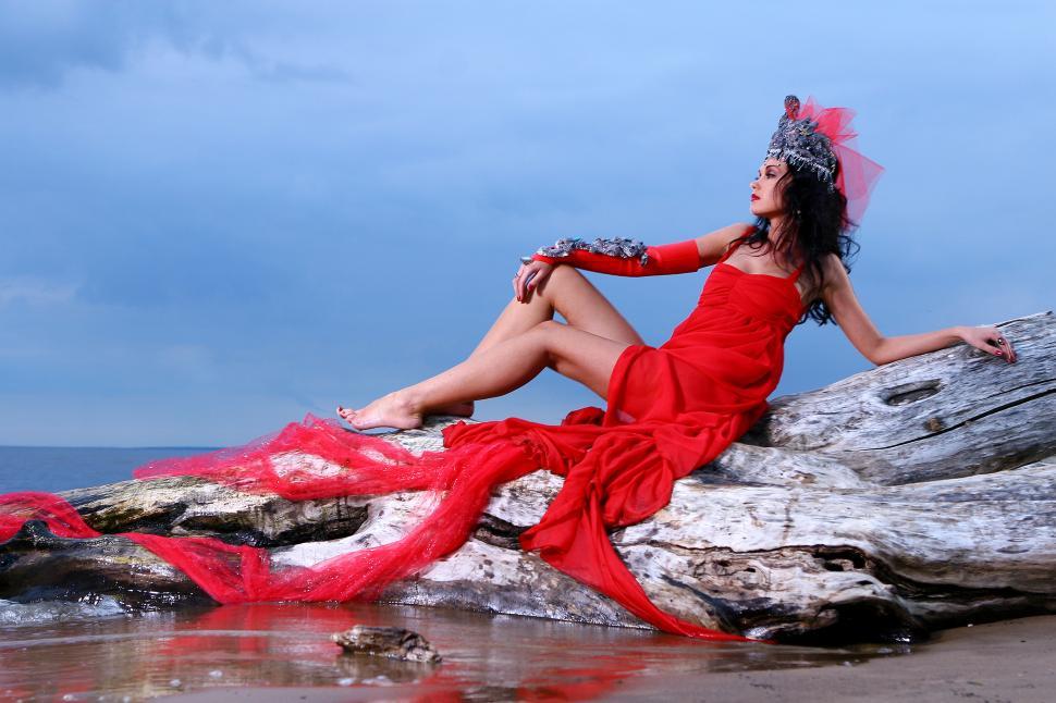 Free Image of Woman in exotic red dress on the beach 