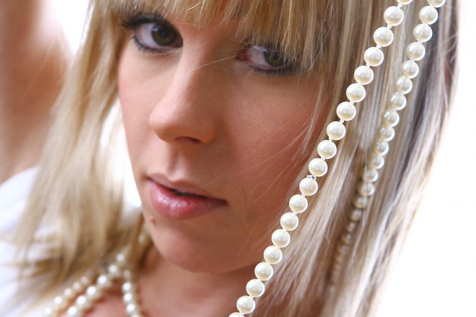 Free Image of Young woman and strings of pearls 