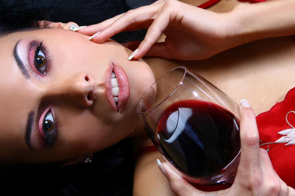 Free Image of Close up of a woman with a glass of red wine 