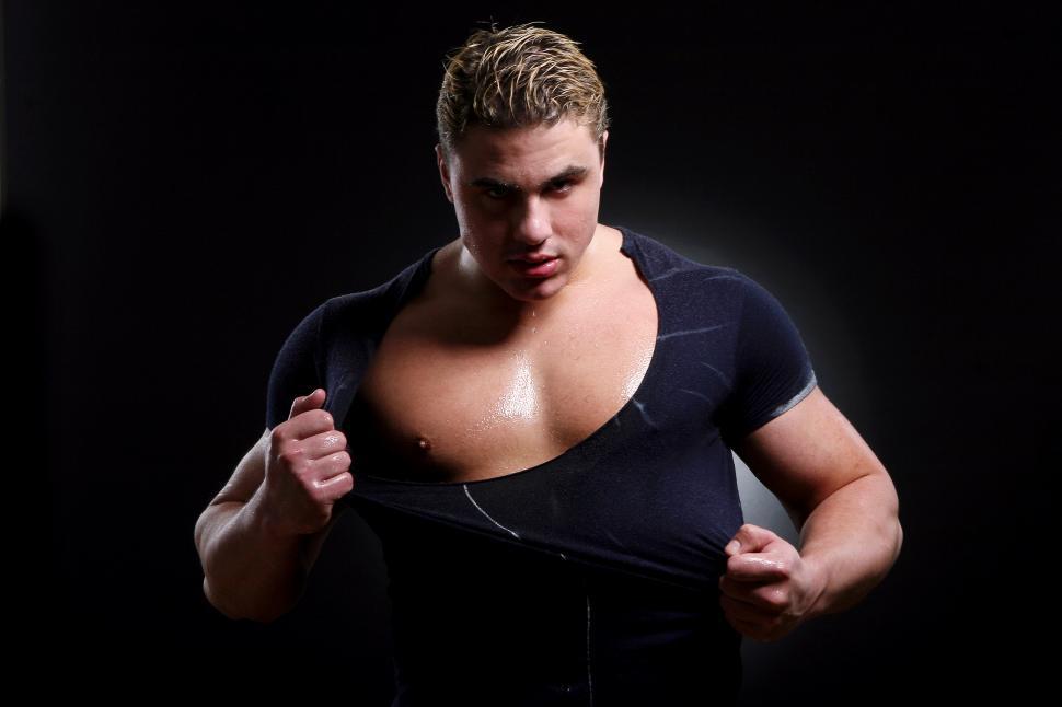 Free Image of Muscular dude tearing off shirt 