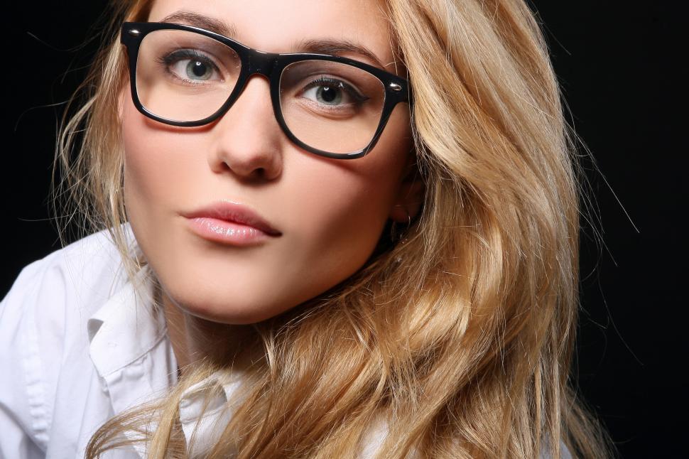 Free Image of Young blonde woman in dark frames  