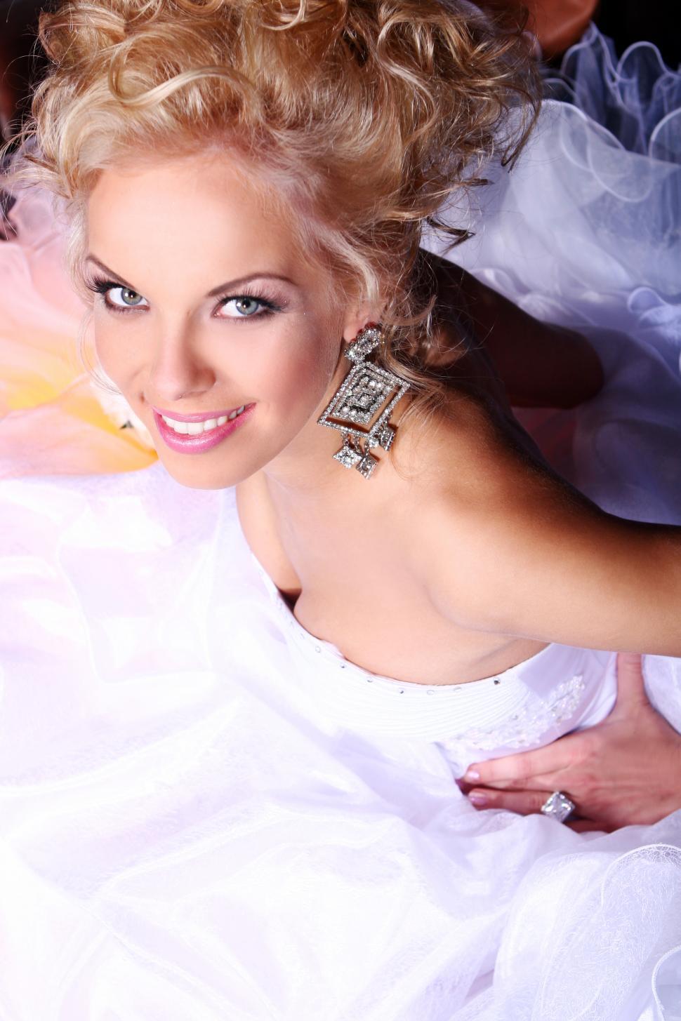 Free Image of Young and beautiful bride in wedding dress, looking up 
