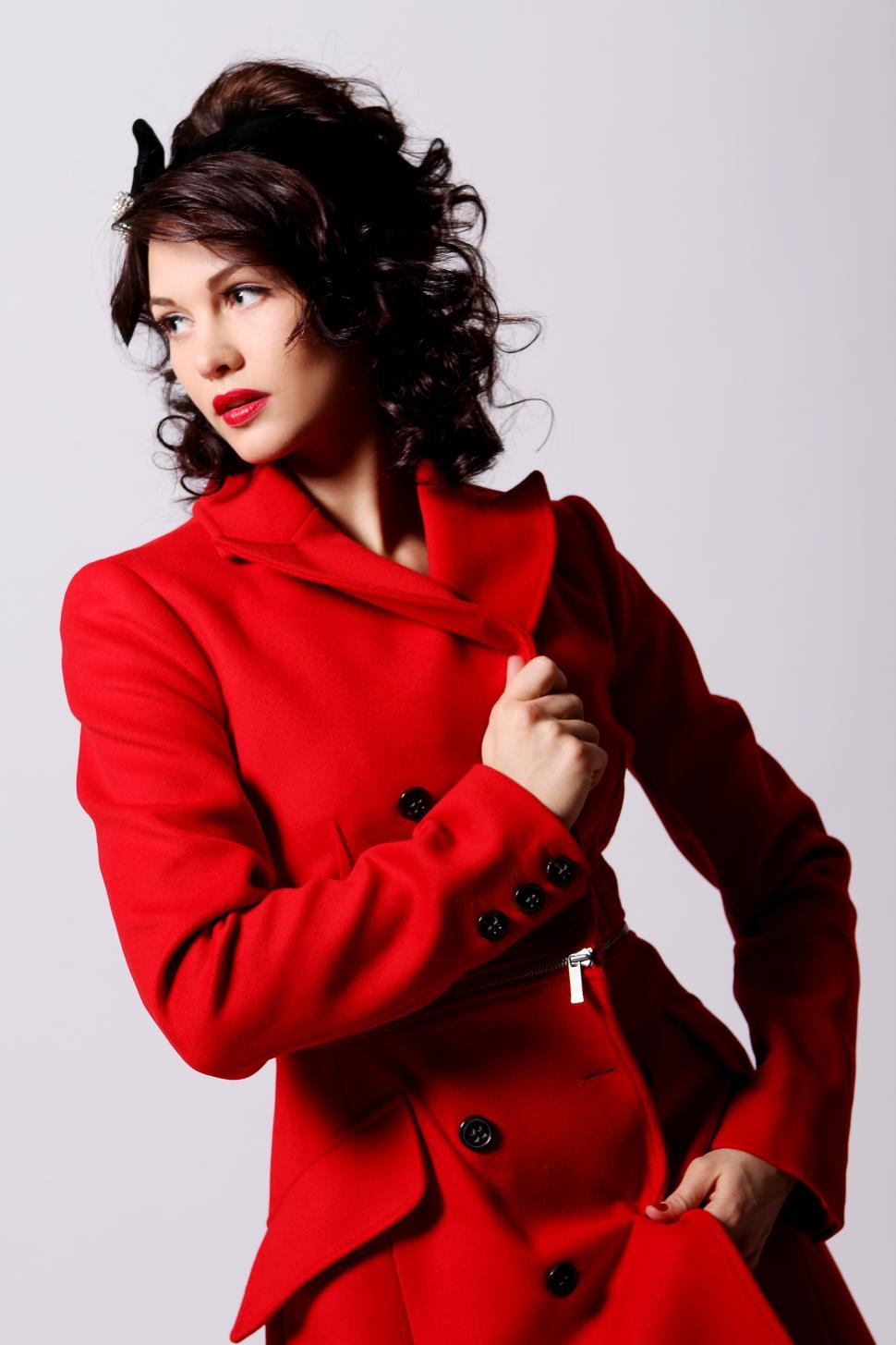 Free Image of Young woman in full length red coat 