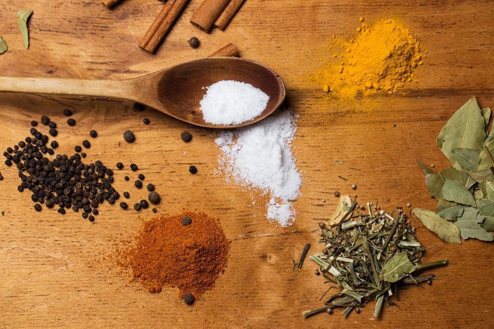 Free Image of Spoon and heaps of spices on the table 