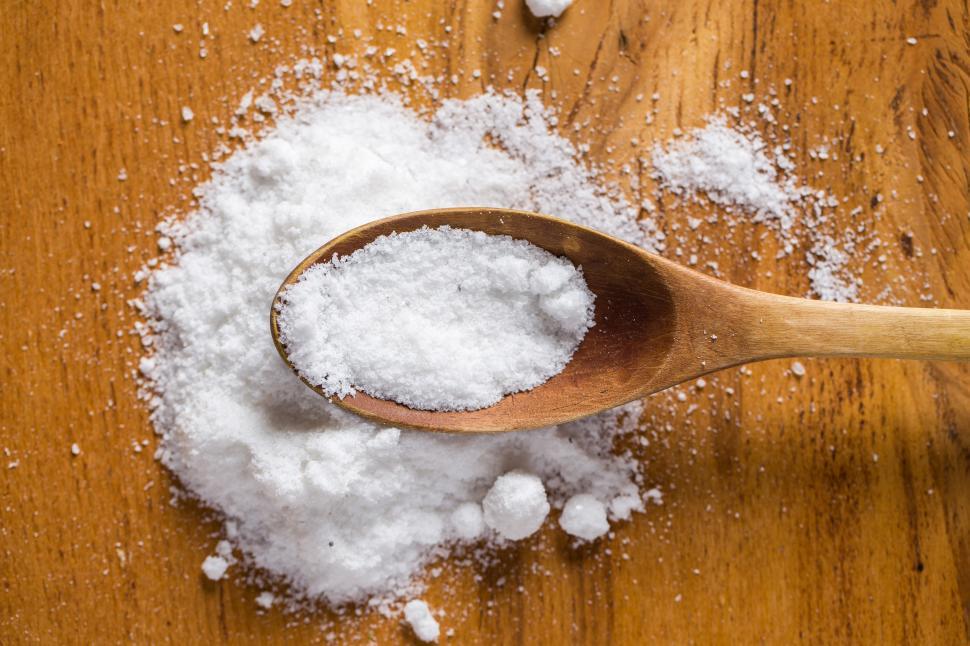 Free Image of Spoon and heap of salt on the table 