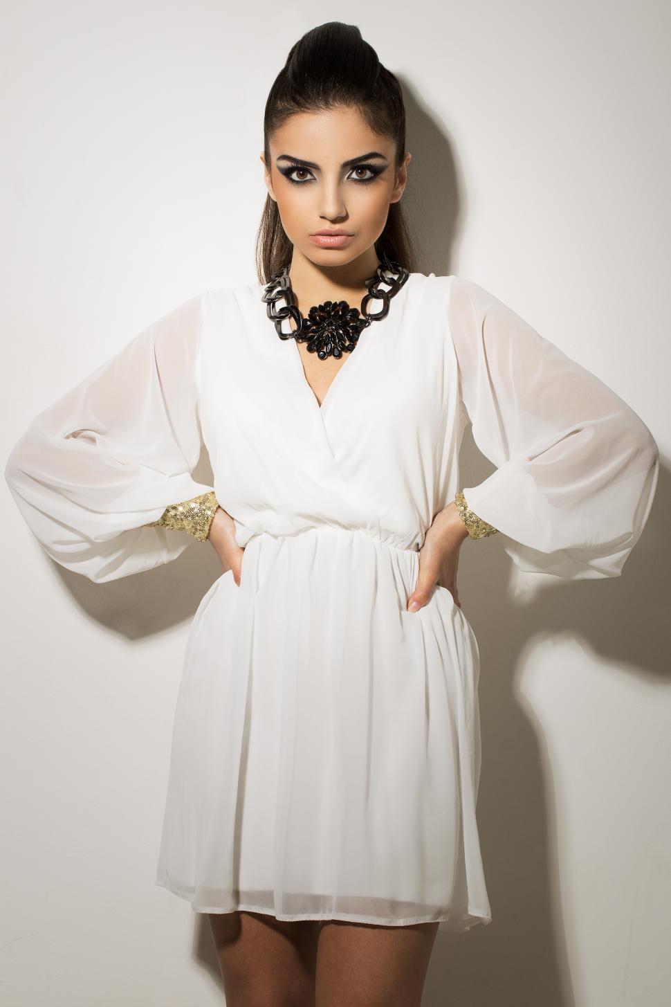Free Image of Vogue. Beautiful woman posing in fashionable white dress 