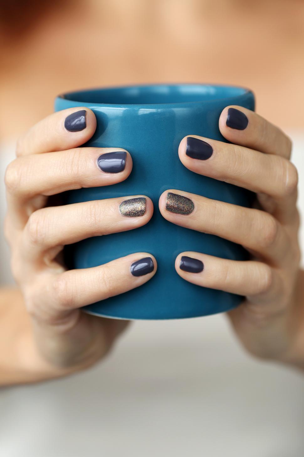Free Image of Hands holding a blue mug 