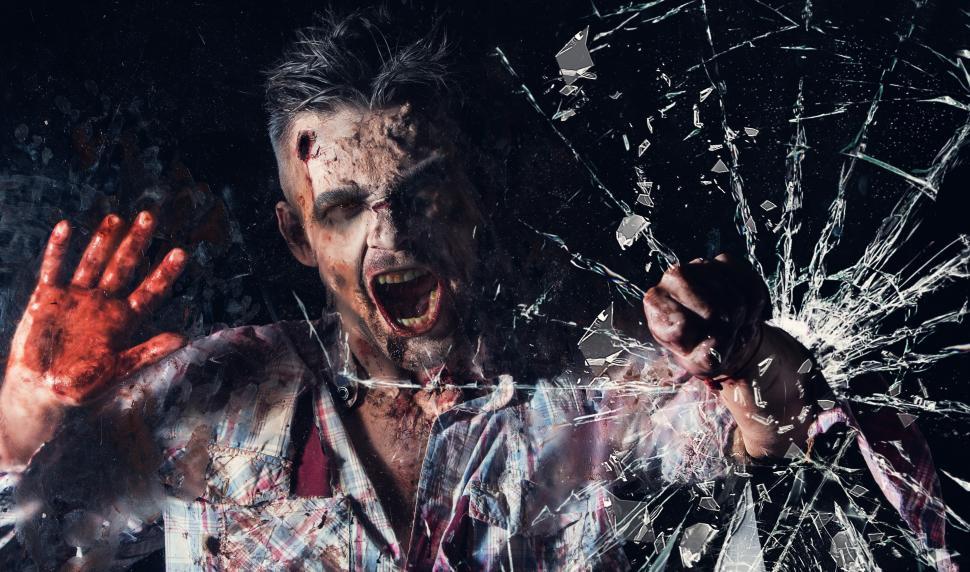 Free Image of Zombie breaking glass window cosplay 