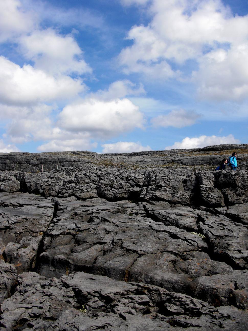 Free Image of Man Standing on Top of Rocky Hillside 