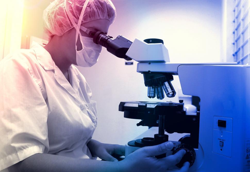 Download Free Stock Photo of Healthcare Professional Analyzing Samples with Microscope 